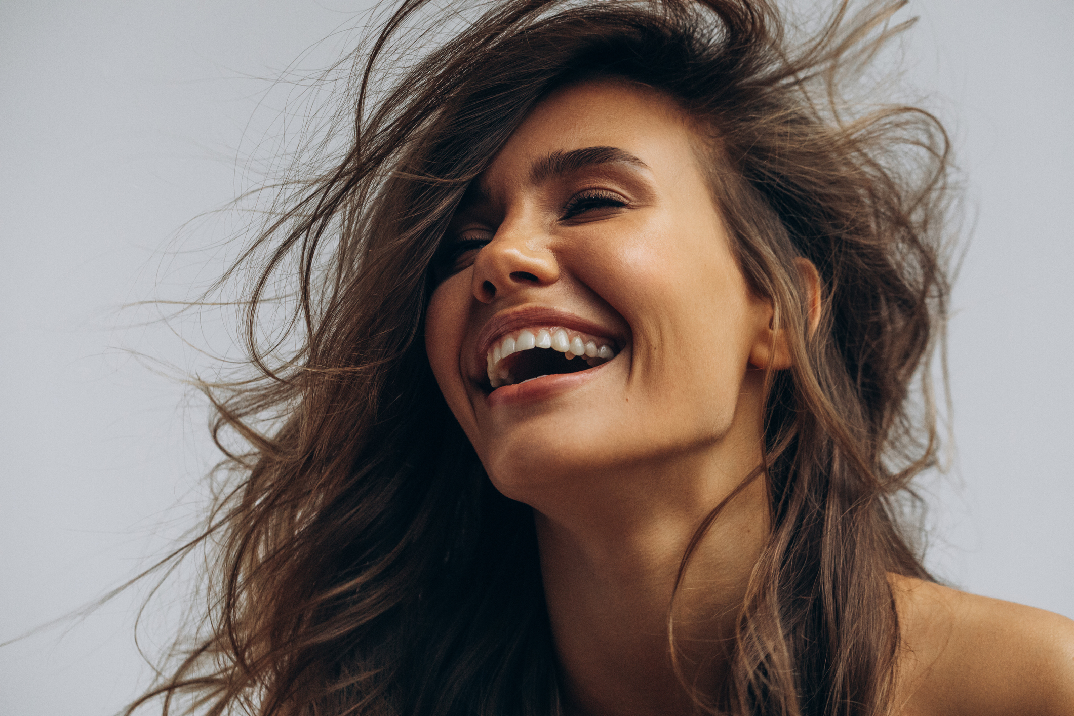 brown-haired woman laughing