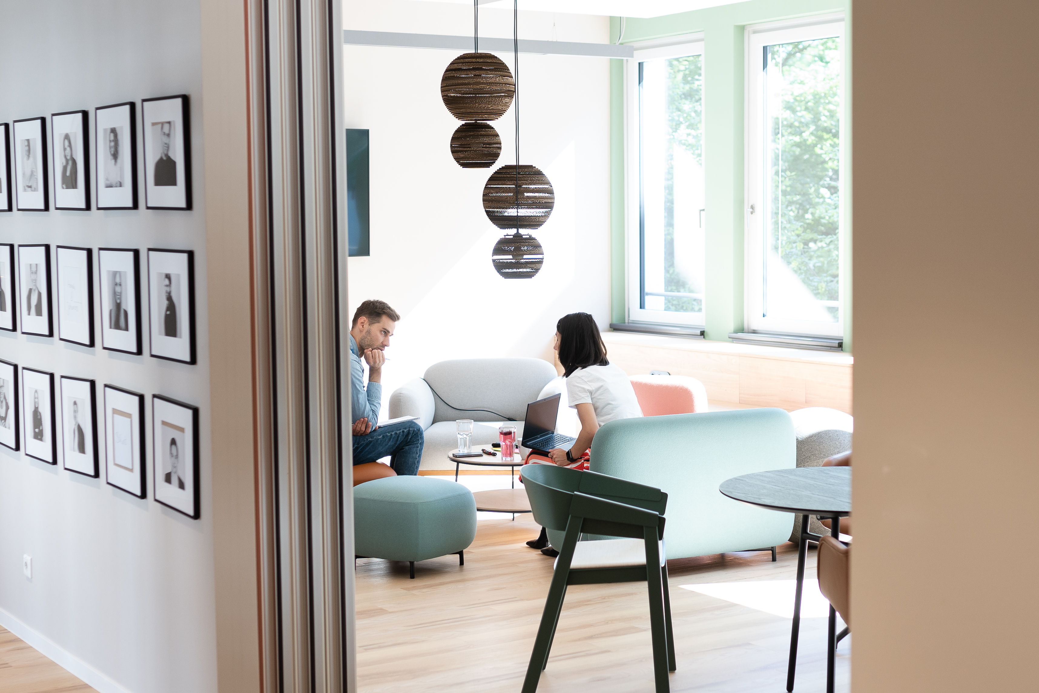 Interior detail with two designers talking to each other in the background