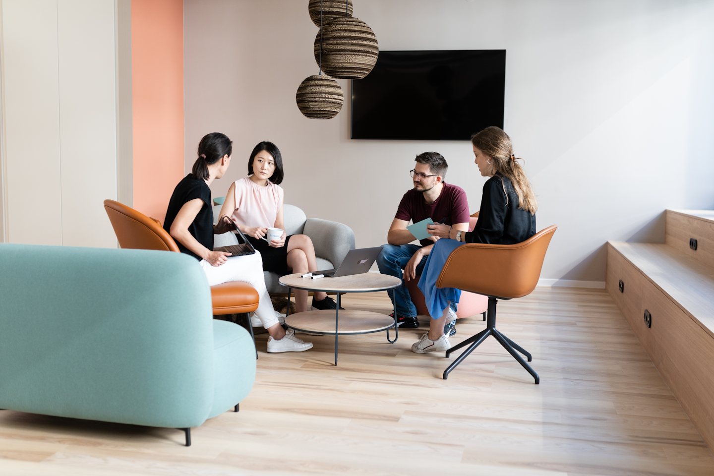 Designers working together while sitting in one of the common areas of the studio