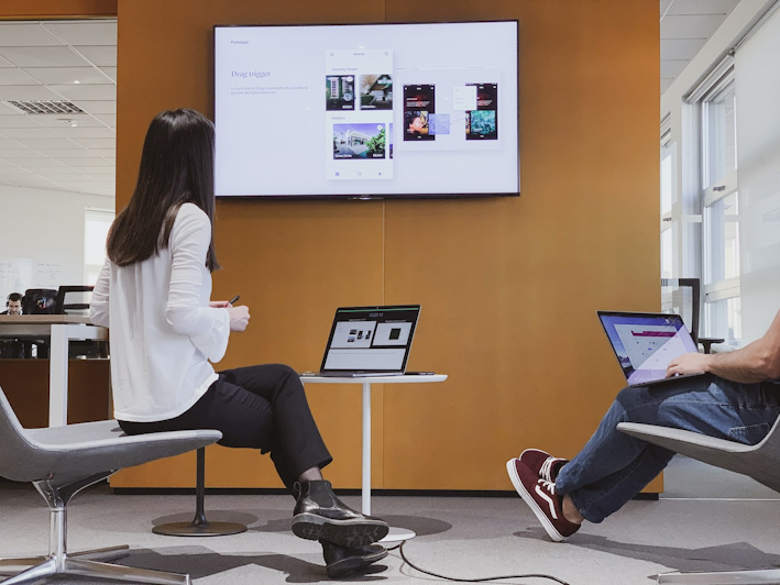 Designers presenting their project, projected on a screen