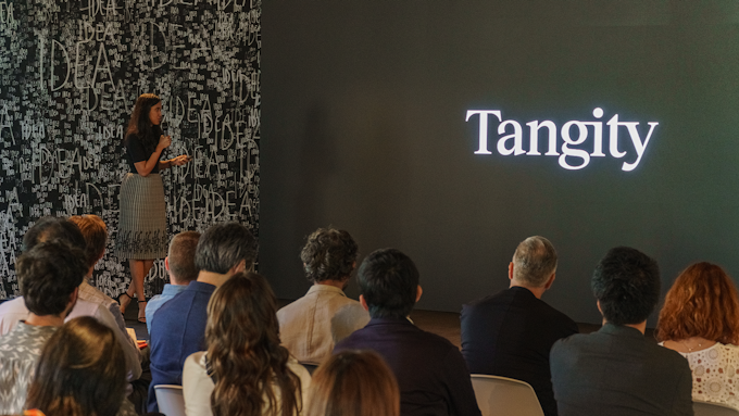 Akanksha Gupta speaking infront of the audience as the event's host