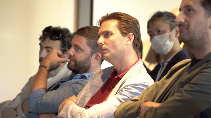 Five men from the audience watching the presentation 