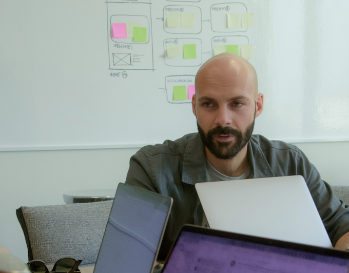 Designer Alessandro Prette sitting in front of computer