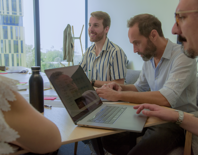 Four designers working at desk