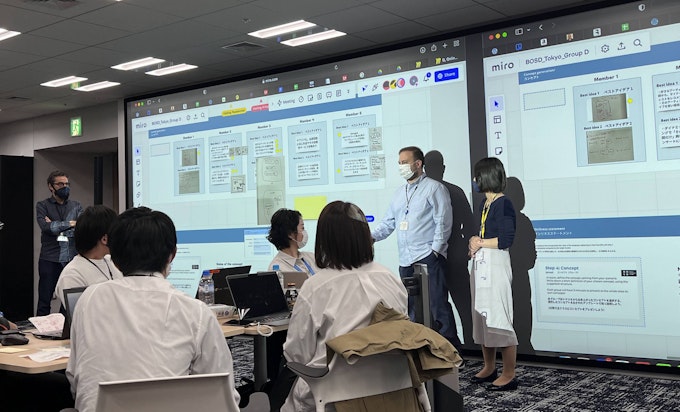 Two people presenting in front of student panel