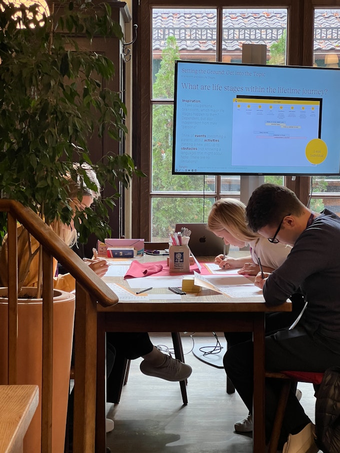 Close-up of workshop participants writing and concentrating.