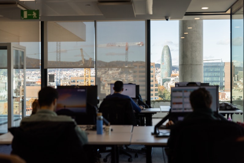 People working at screens in Barcelona Tangity studio with a nice view
