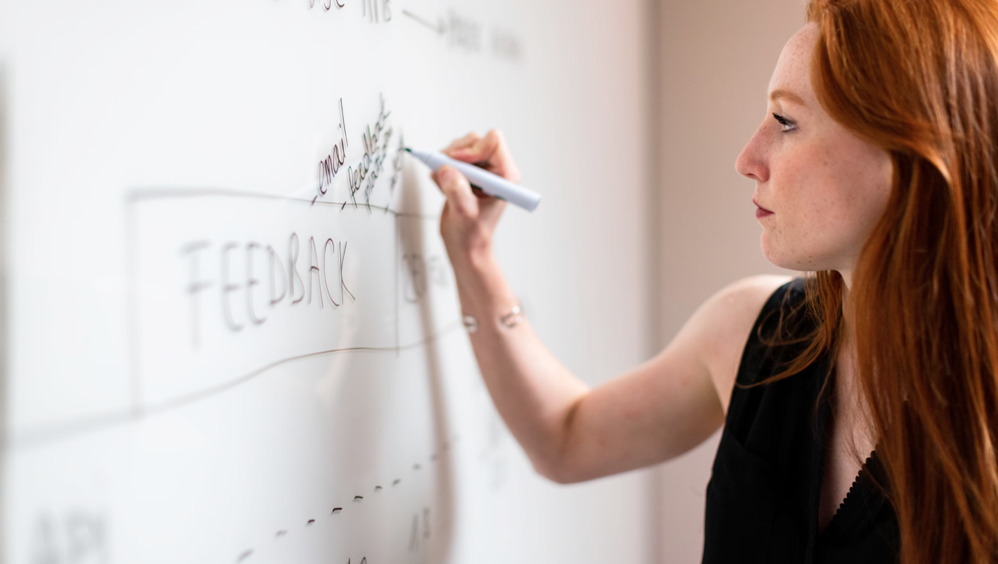 Person writing information on a whiteboard