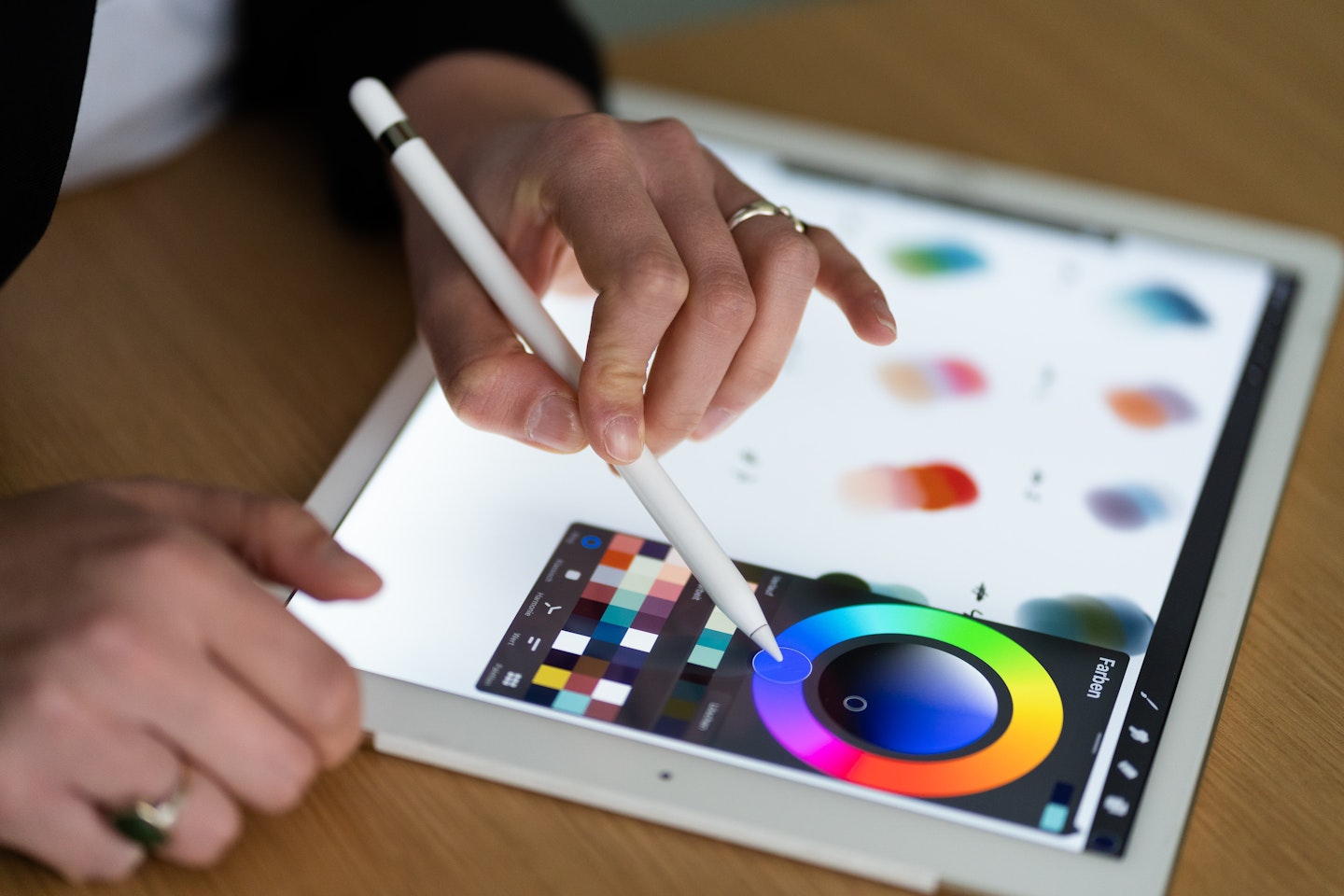 A person working on a color palette with an iPad, trying out the accessibility of colors