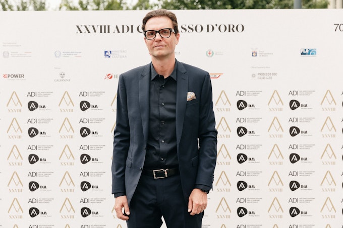 Roberto Roggero, Head of Tangity Italy in front of photo wall
