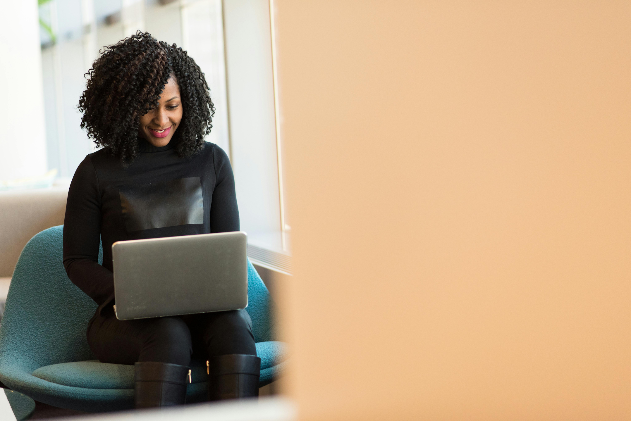 Person working at their laptop smiling