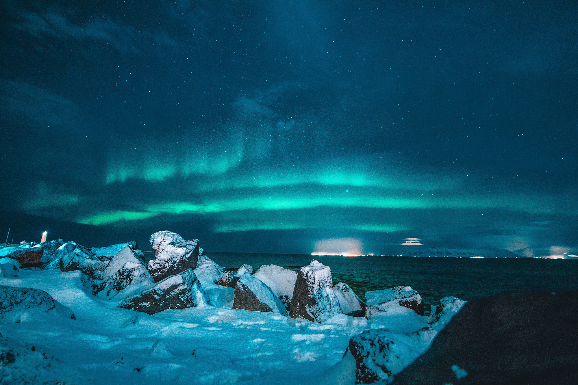 Northern lights over snowy mountain