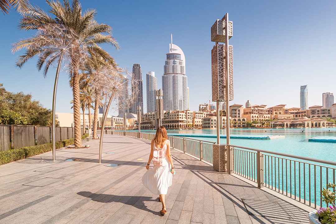 Woman walking along boardwalk in Dubai