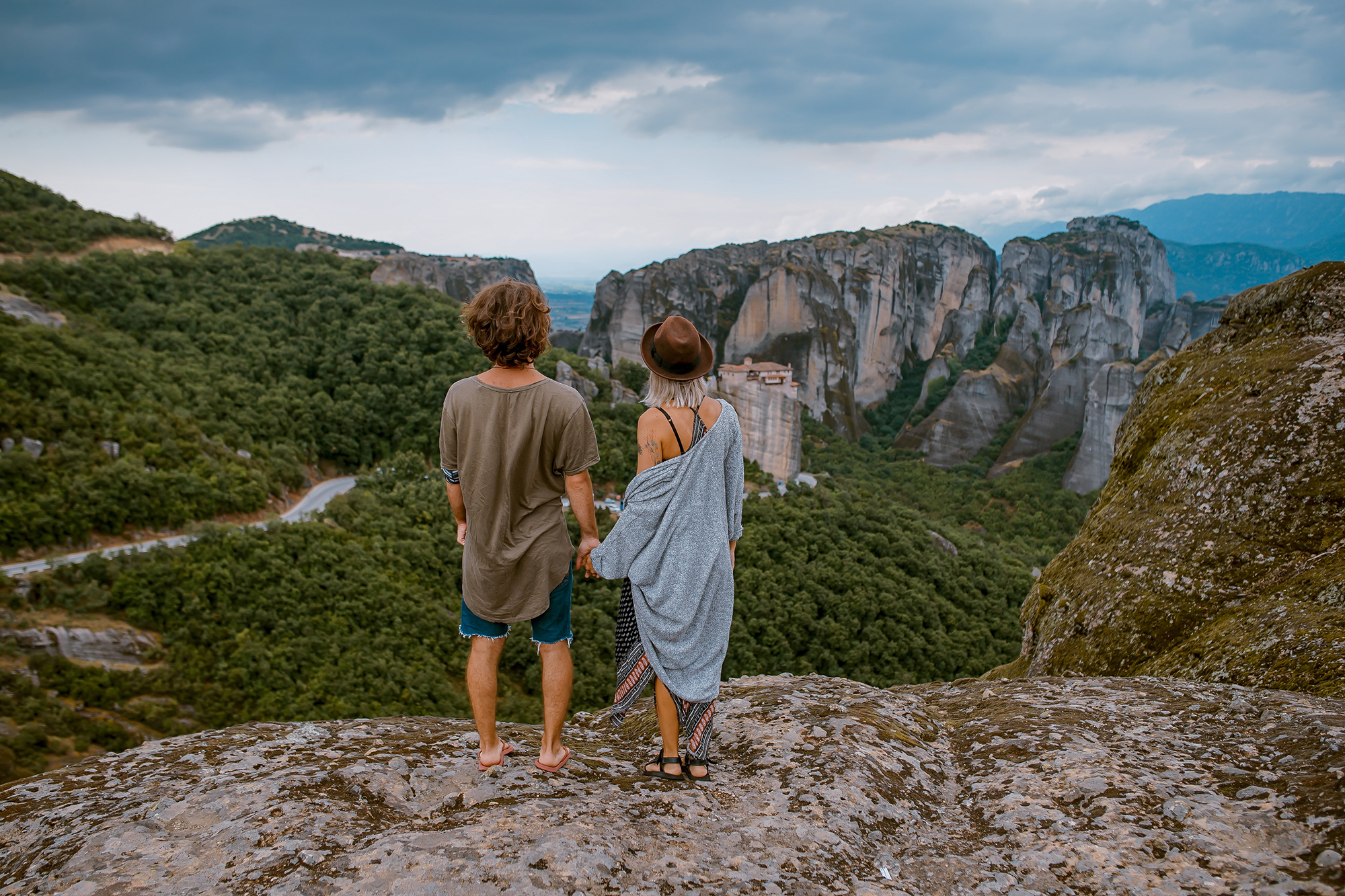 Young couple standing on cliff enjoying view 