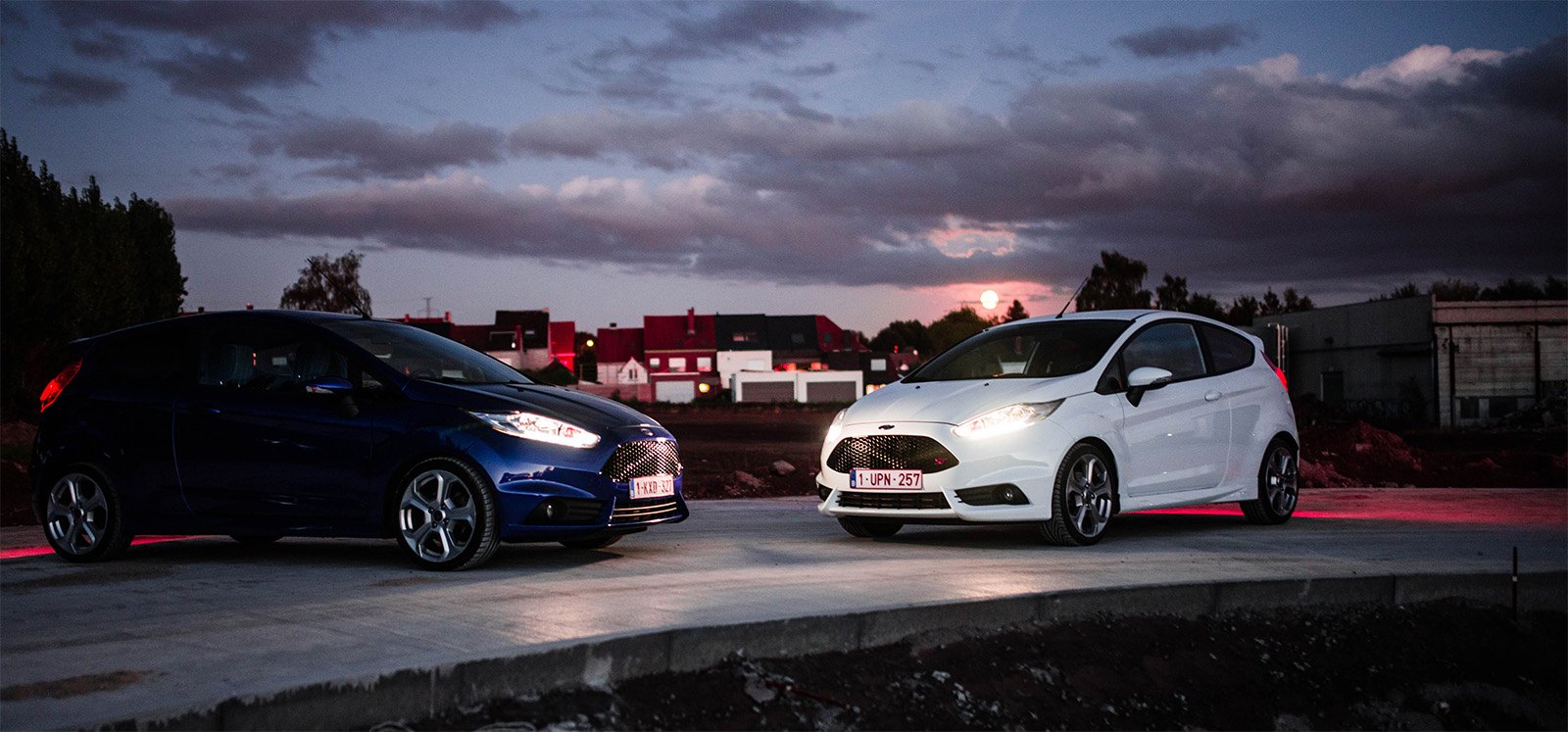 Two rental cars at night