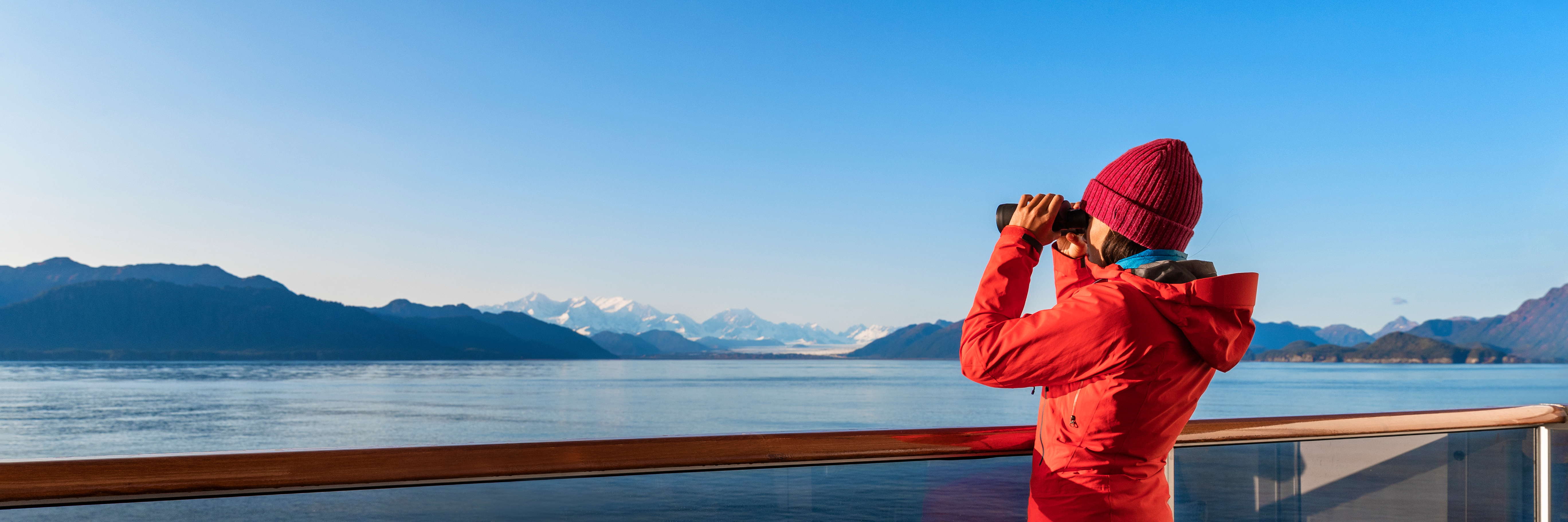 Passenger looking through binoculars while on ship up north