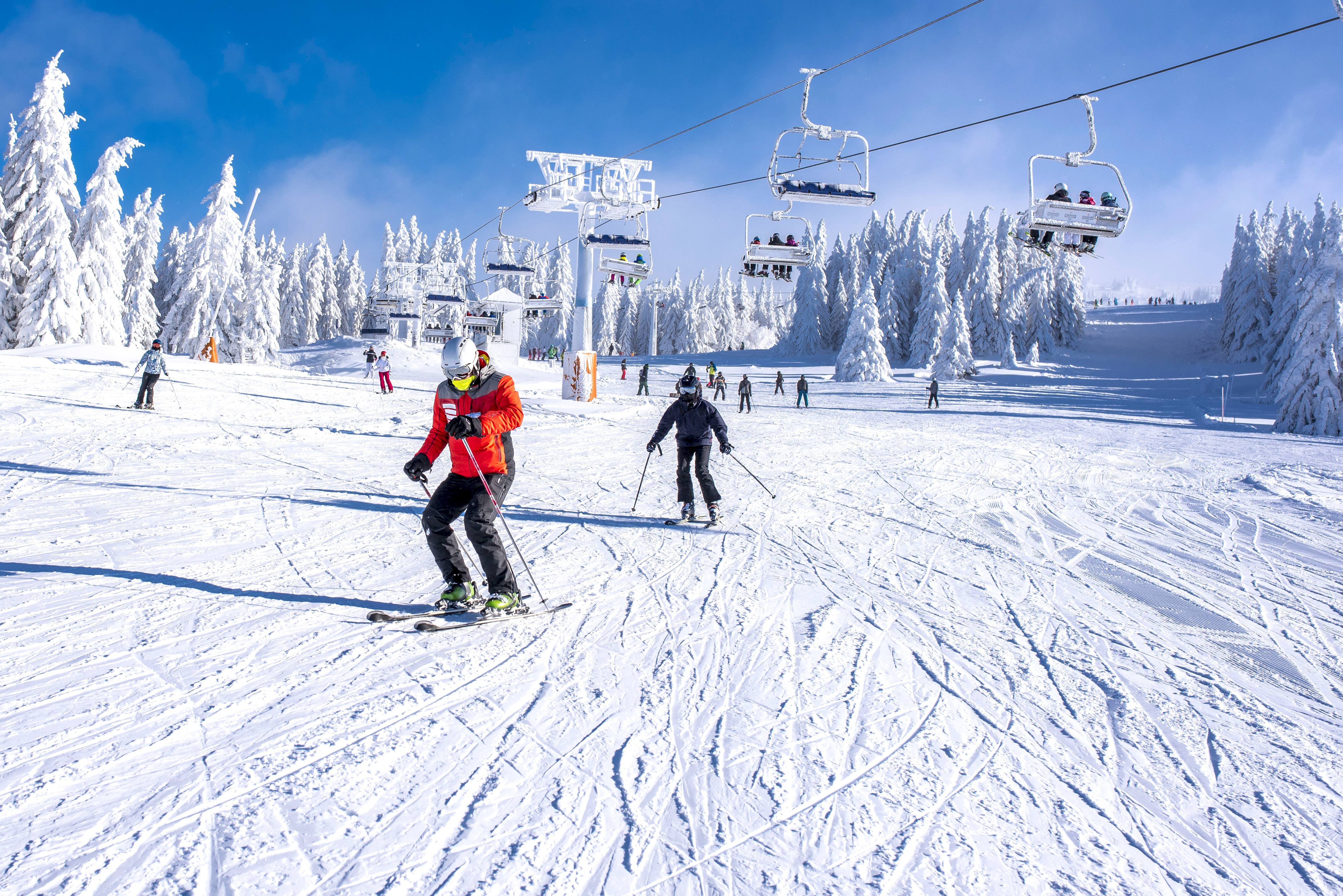 People skiing down ski hill 