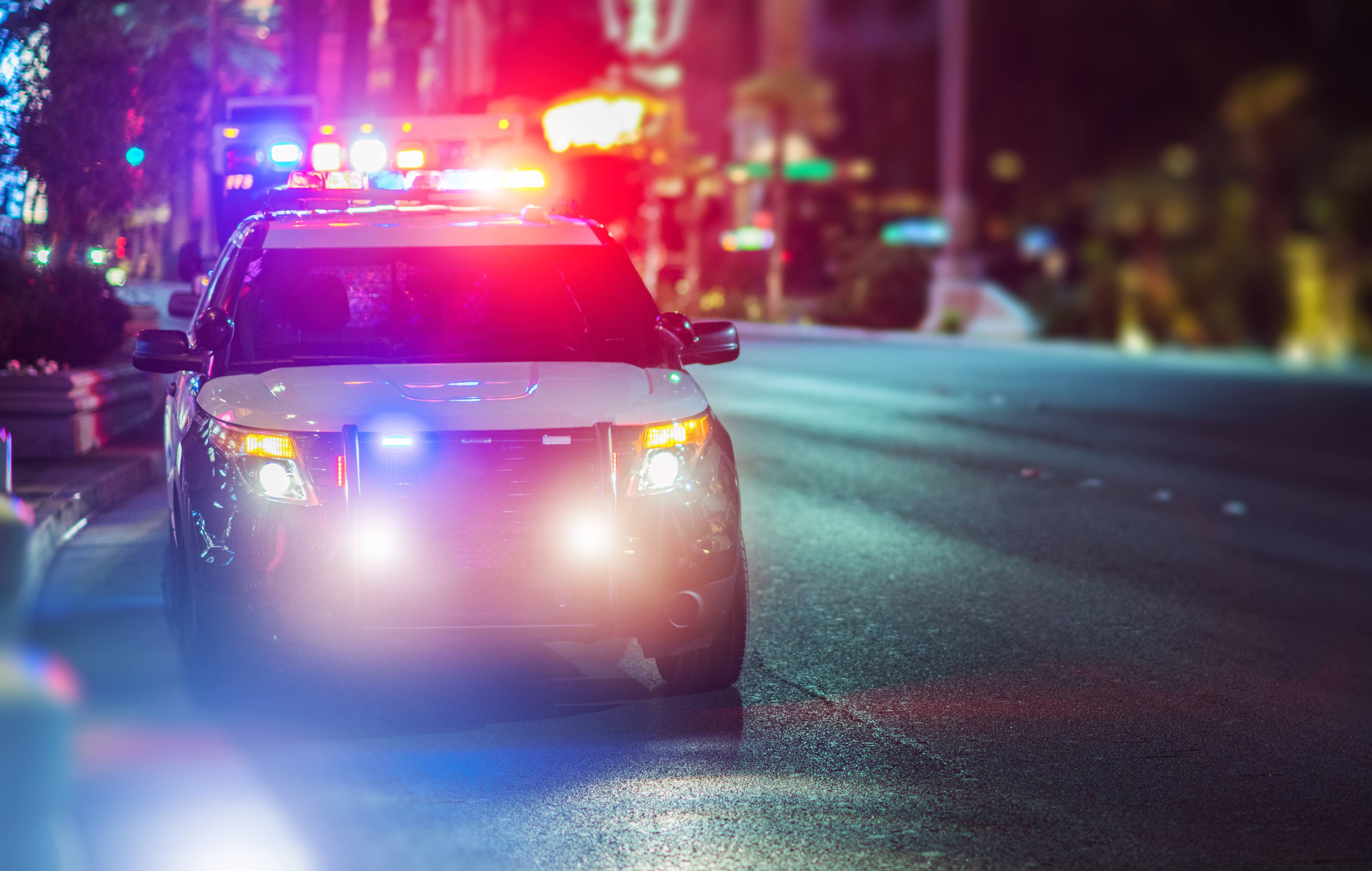 Police car with lights flashing at night