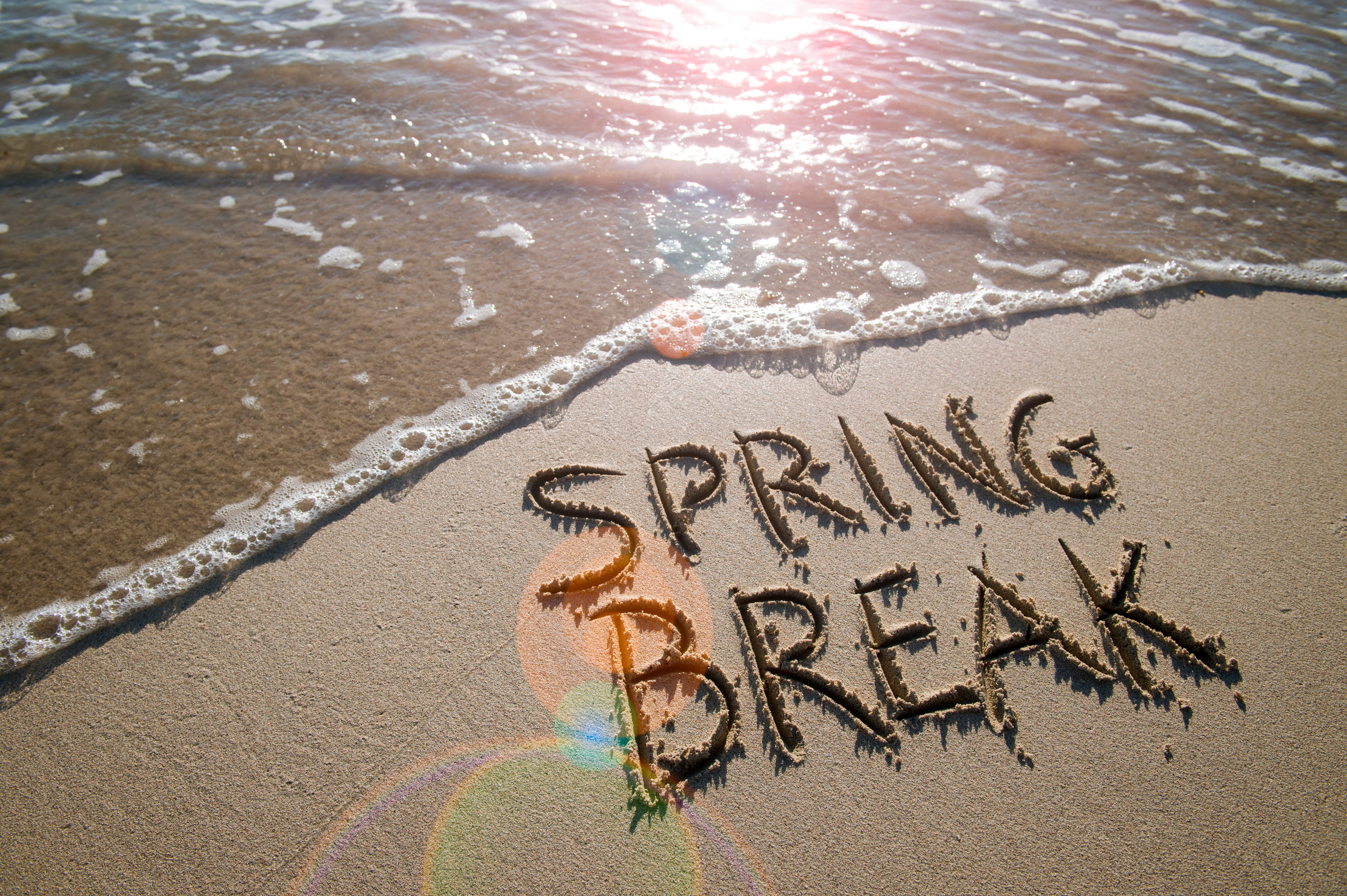 Spring break written in the sand of beach