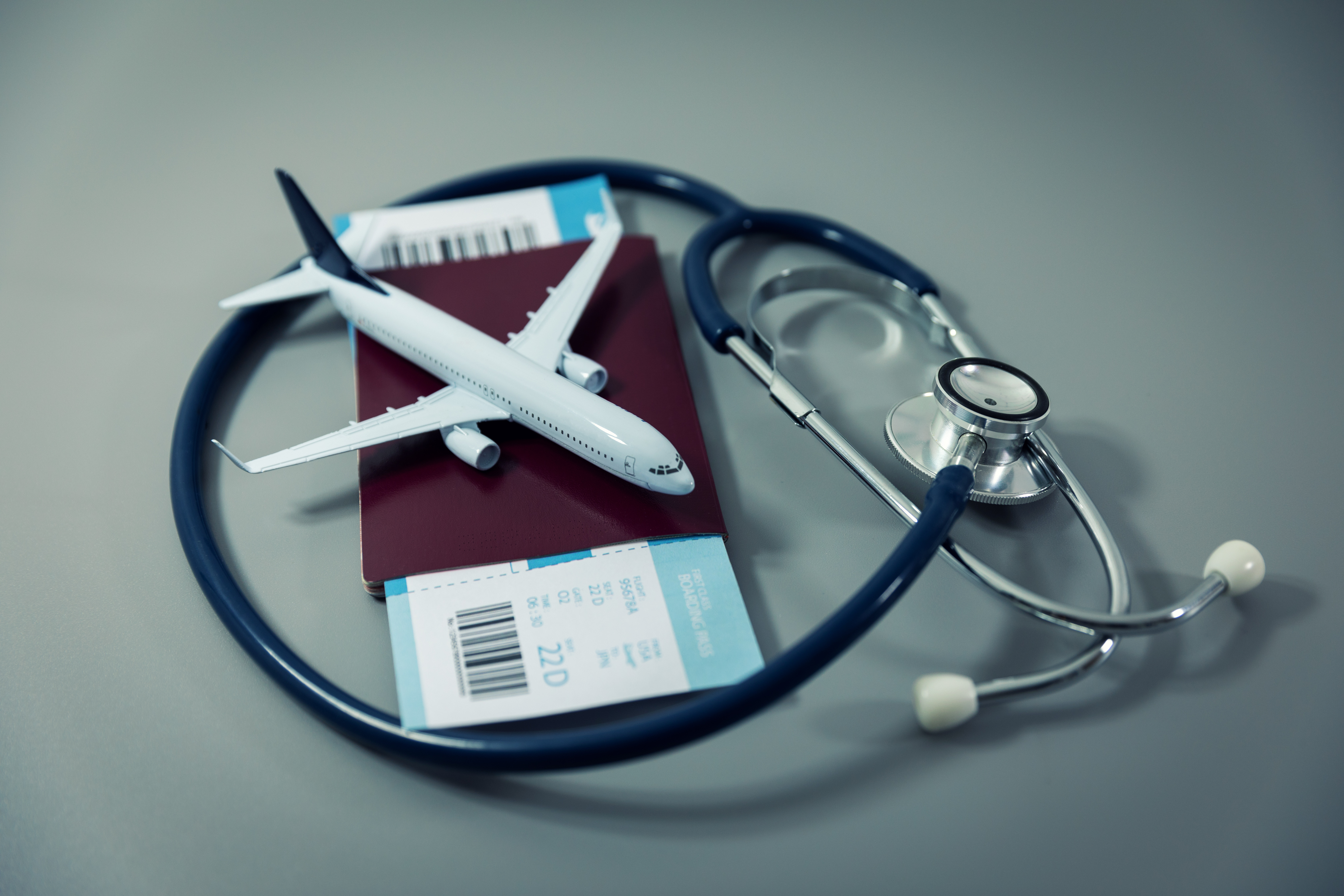 Tickets, passport, toy plane and stethoscope