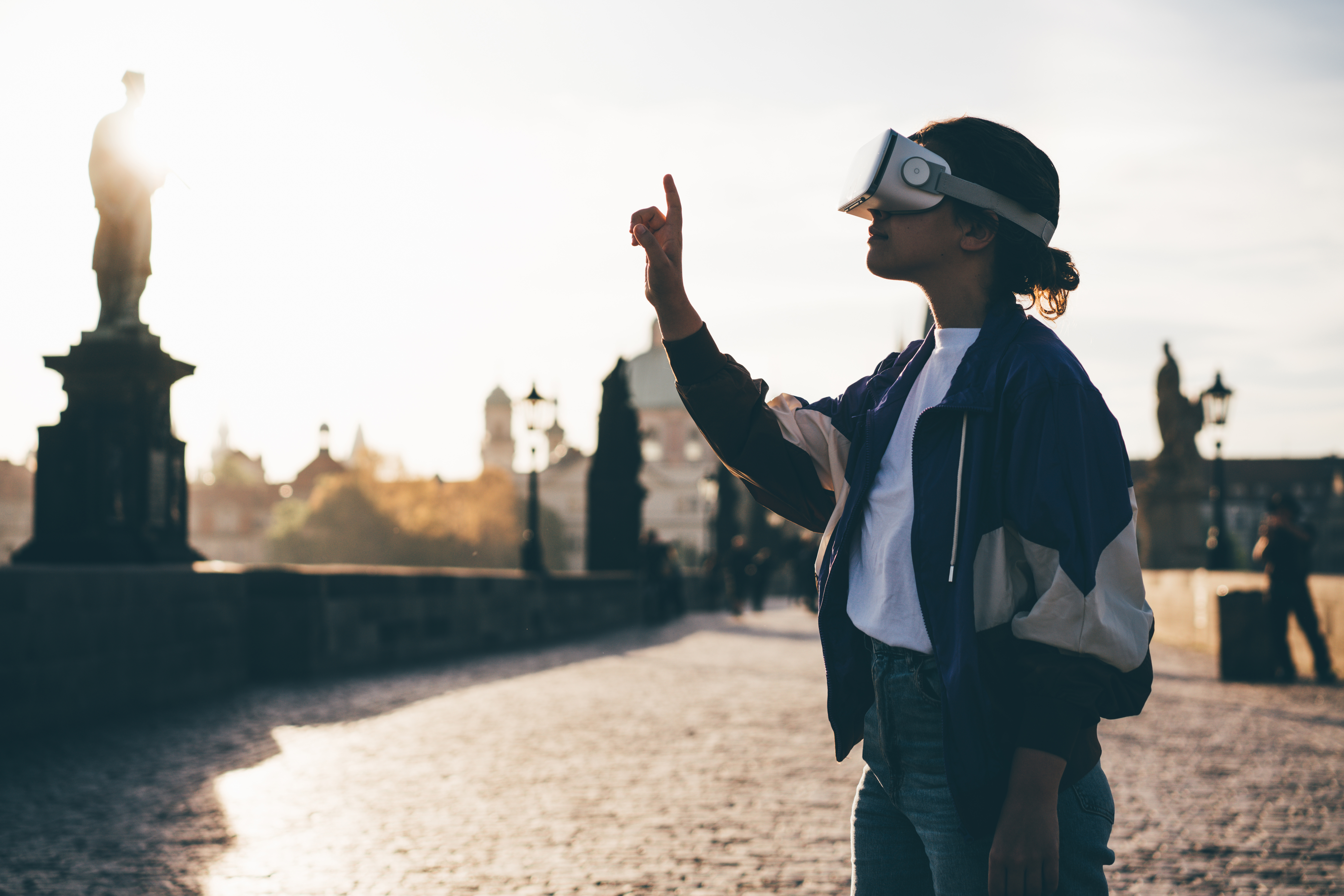 Woman in VR headset on historic bridge