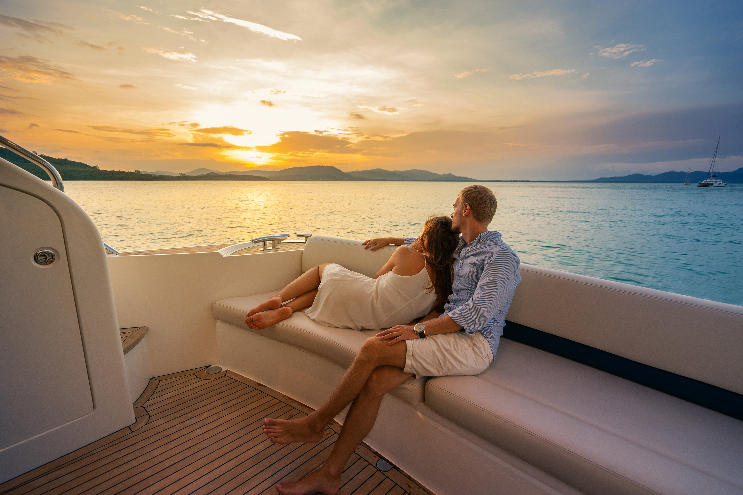 Couple sitting on boat watching sunset