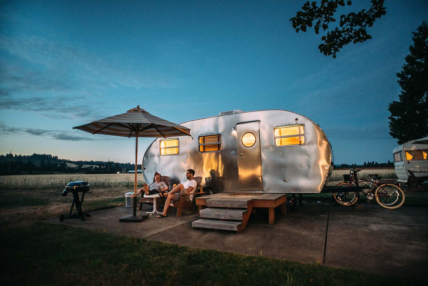 Couple outside camper at night