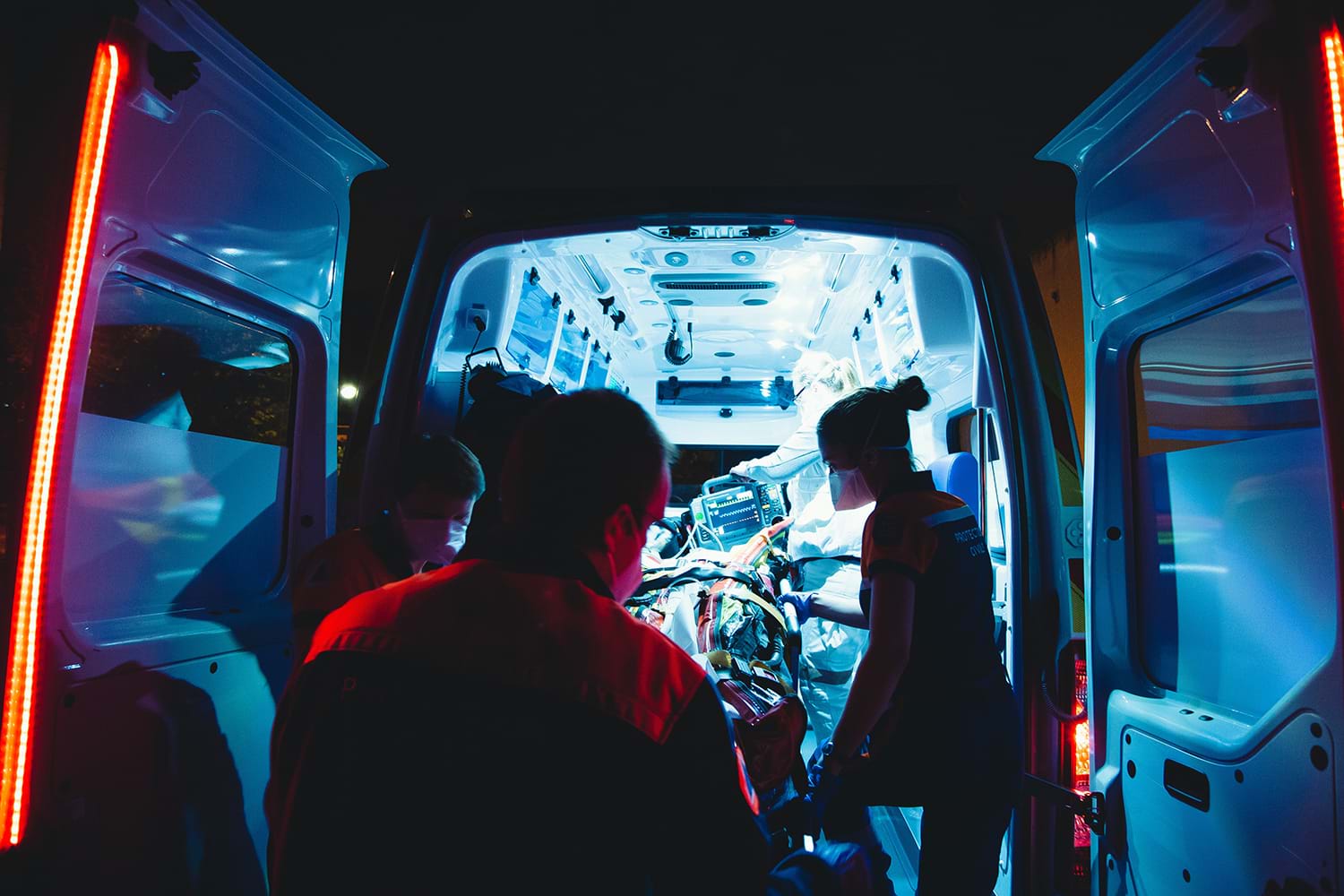 Small ambulance with paramedics at night