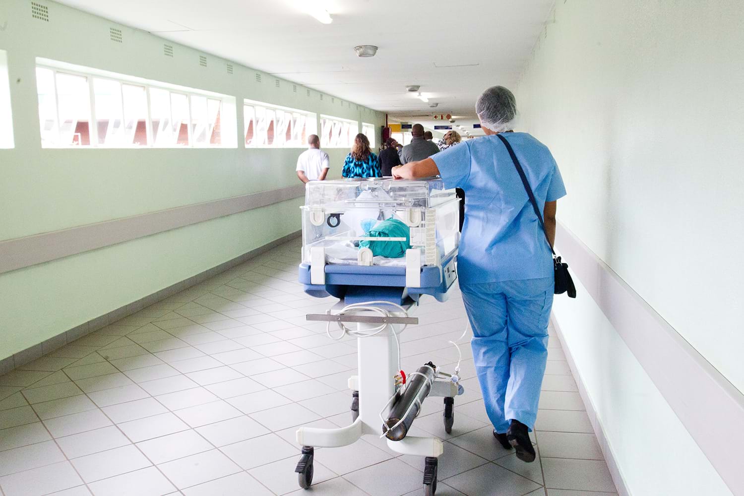Hospital worker wheeling a cart 