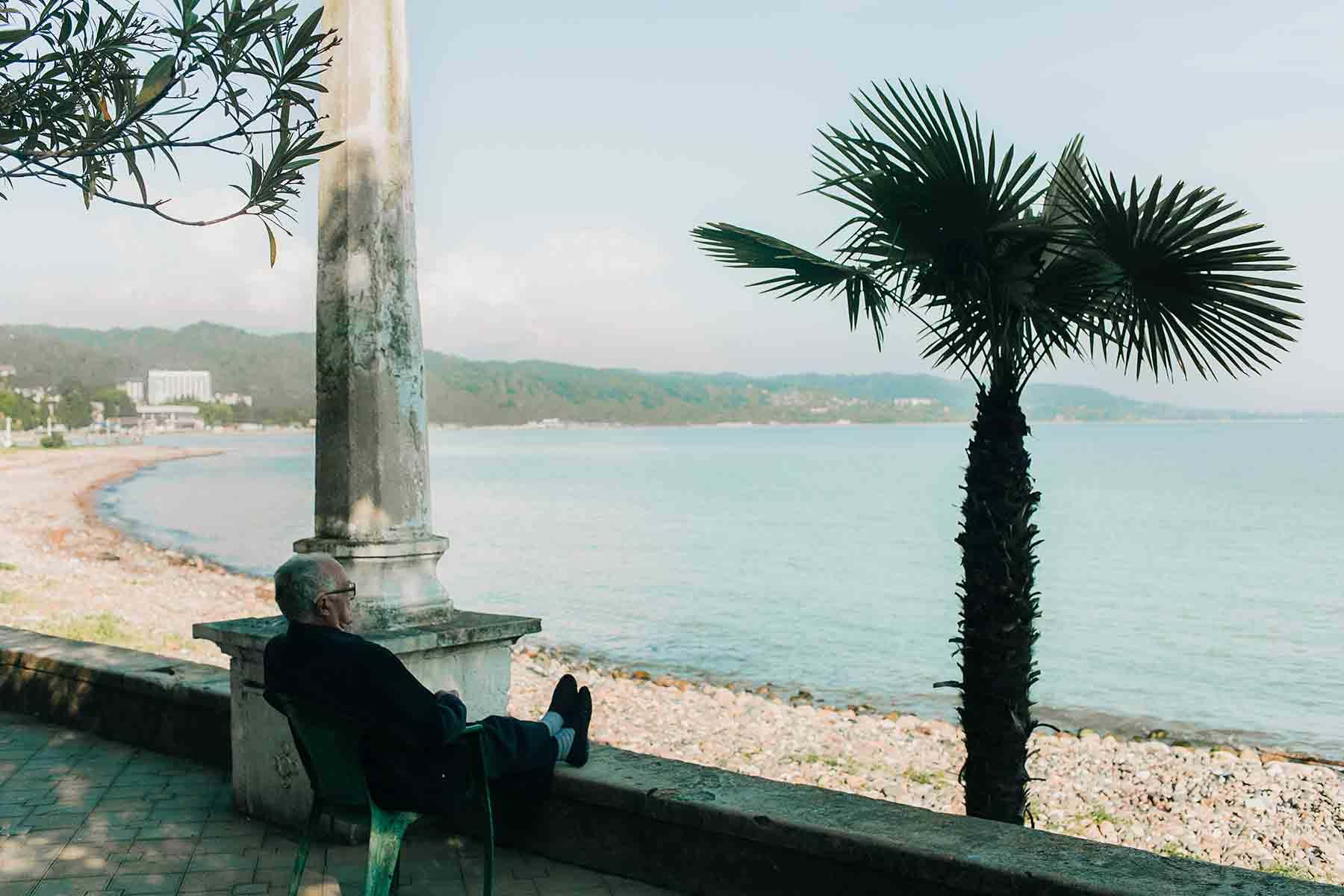 Man sitting in chair watching the coast