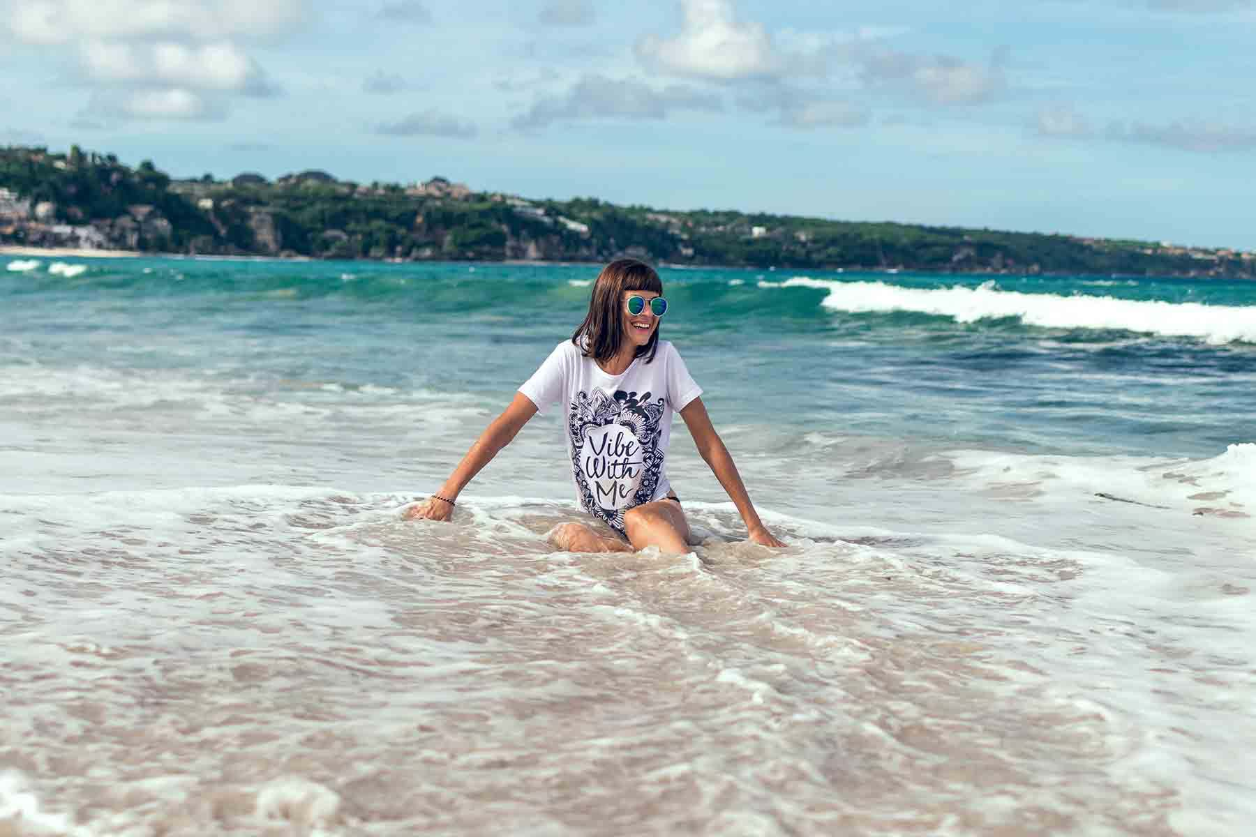 Woman sitting in water at a beach