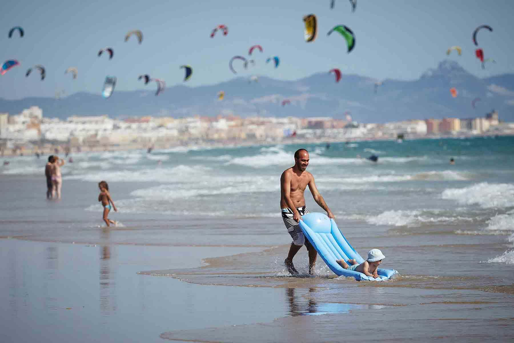 Dad playing with child on beach