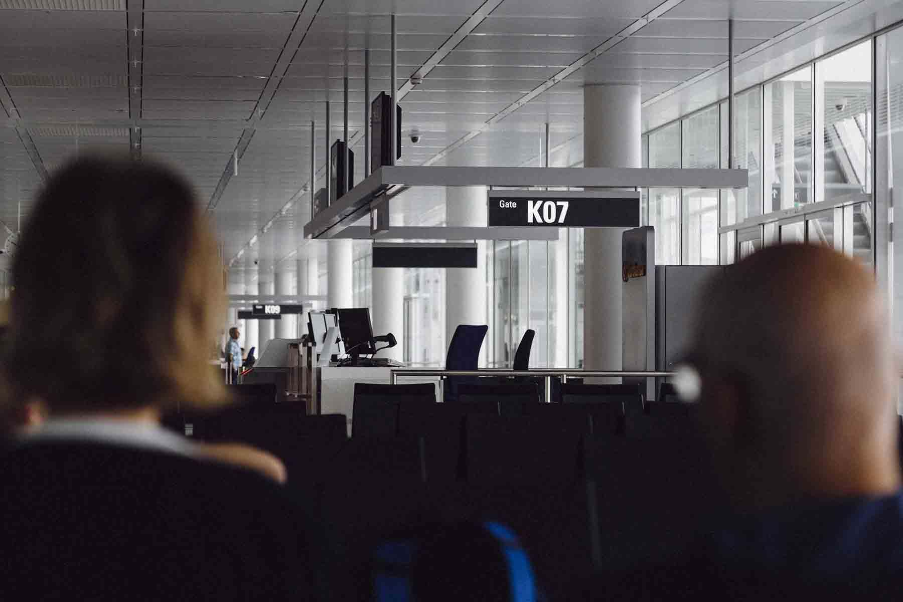 People waiting for their flight at airport gate