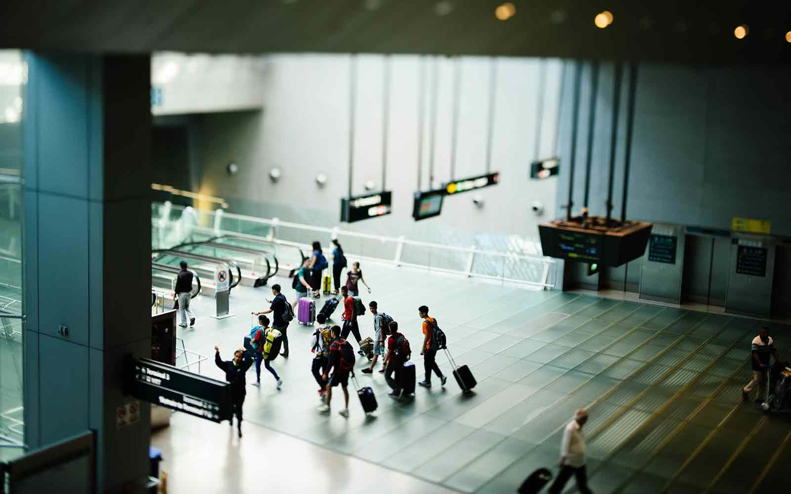 People moving to airport escalator