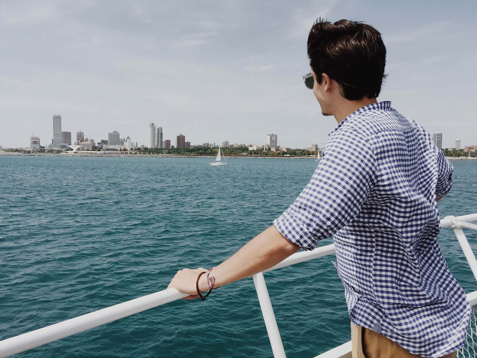 Young man leaning on ship railing