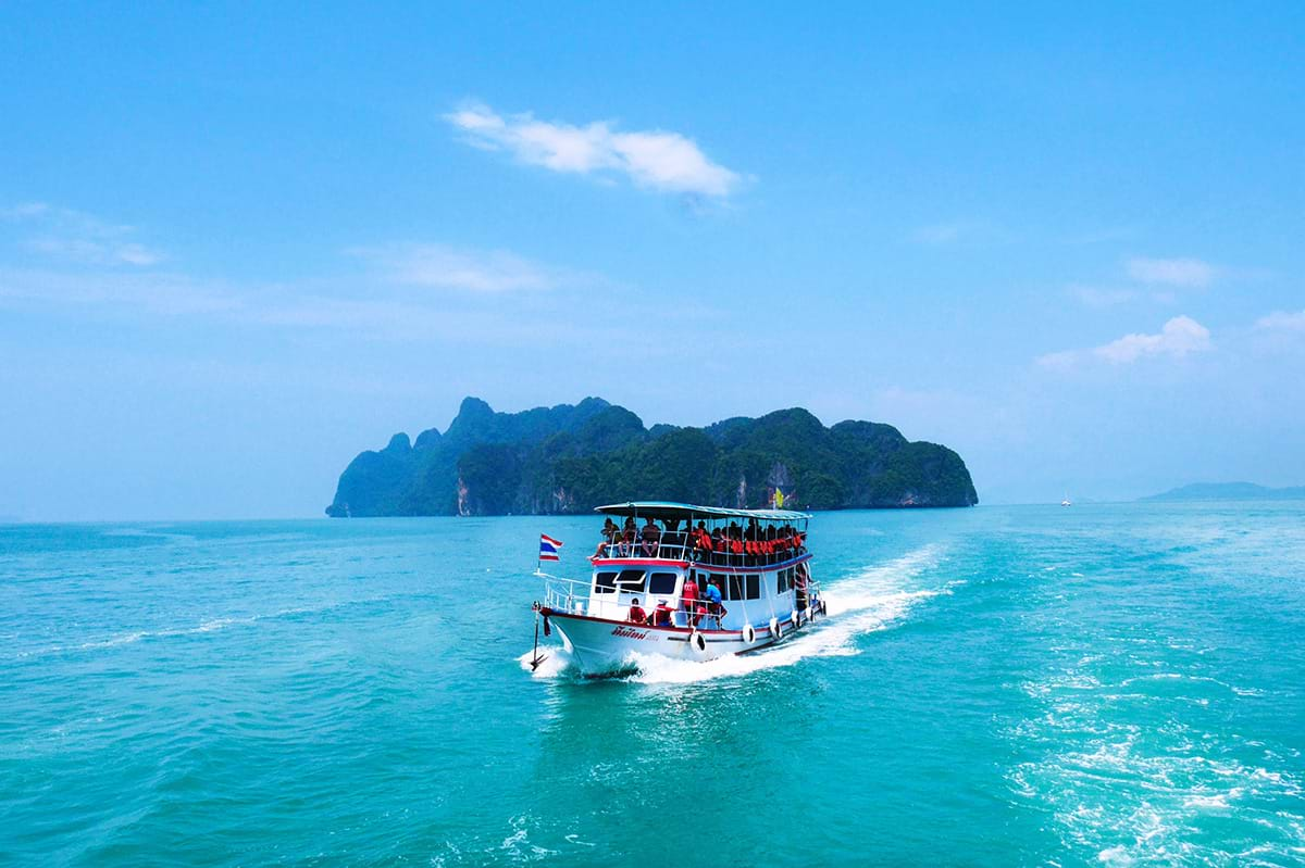 Tour boat moving past island