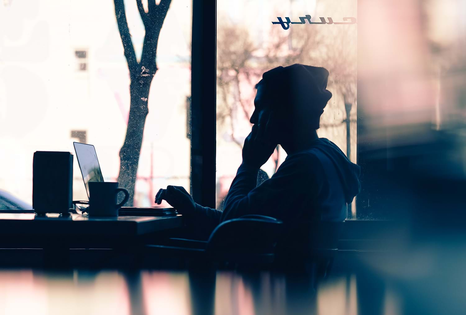 Silhouette of person sitting in cafe