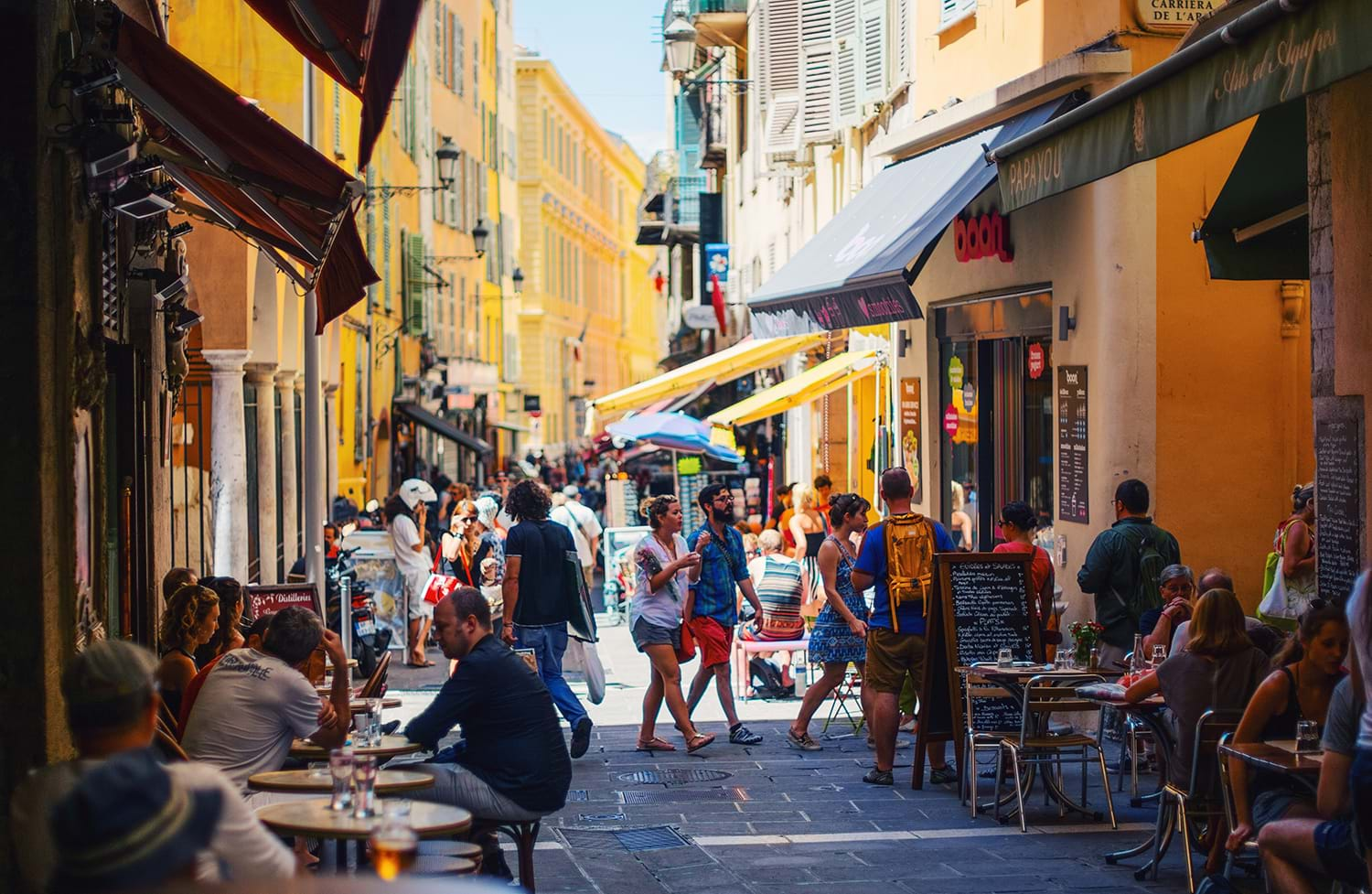 Crowded street with shops and restaurants