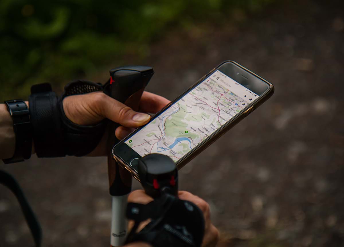 Person hiking while using a map on their phone