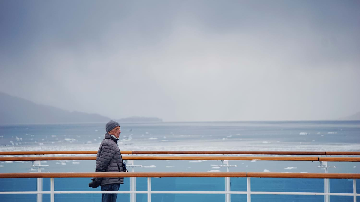 Man on deck of ship in icy waters