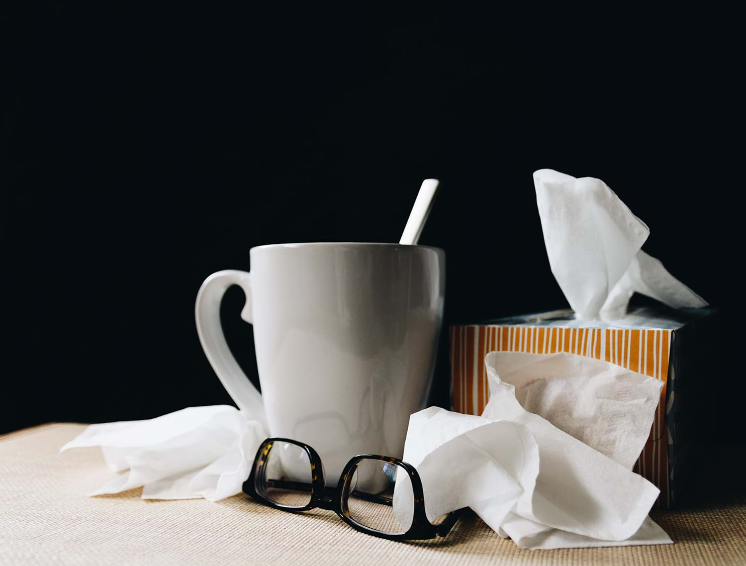 Mug, glasses, and box of tissues