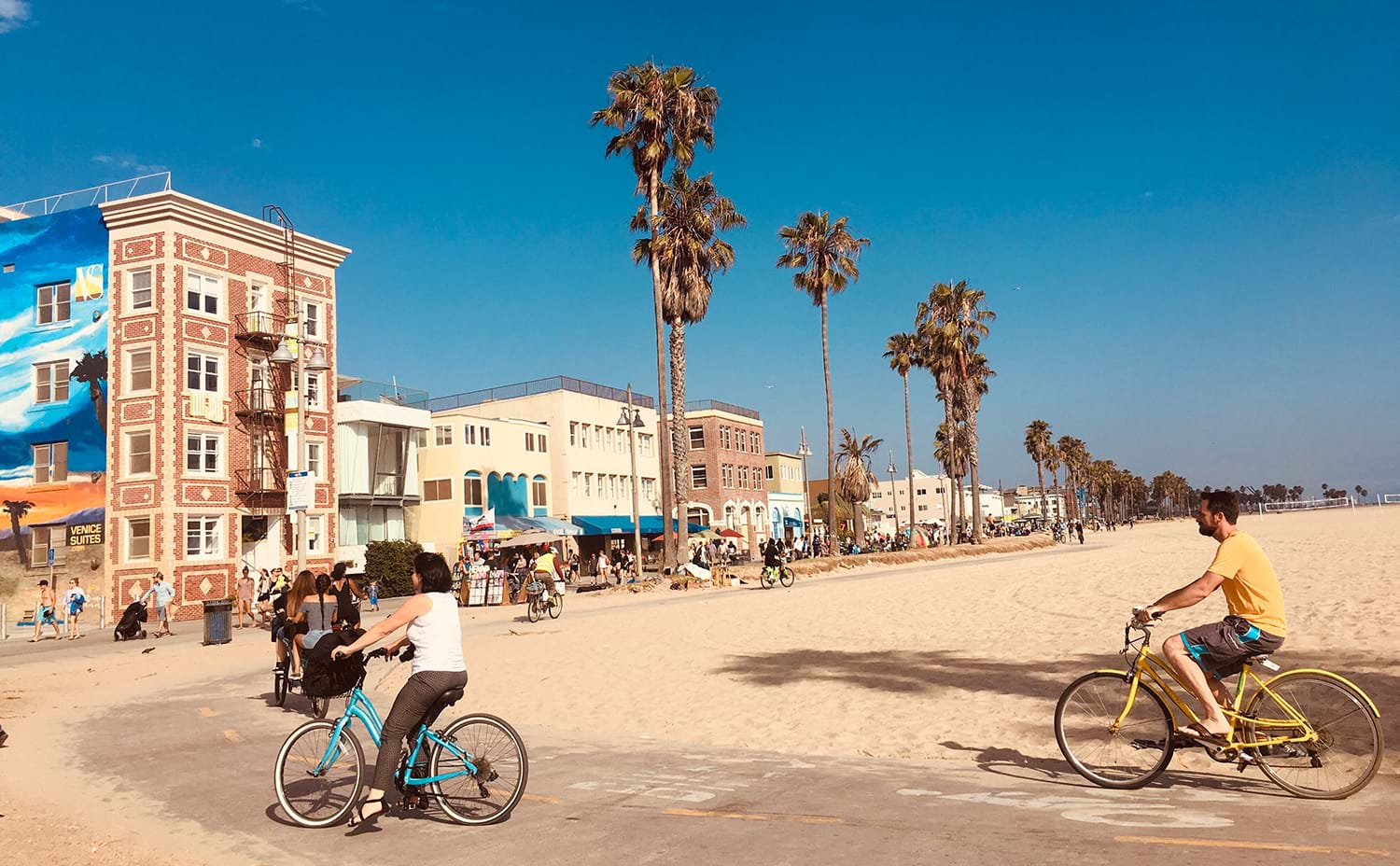 People biking by beach vollyball area