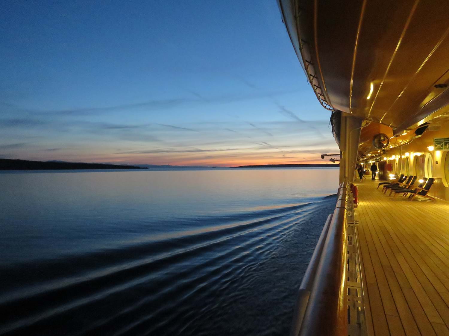 Side deck of cruise ship at dusk