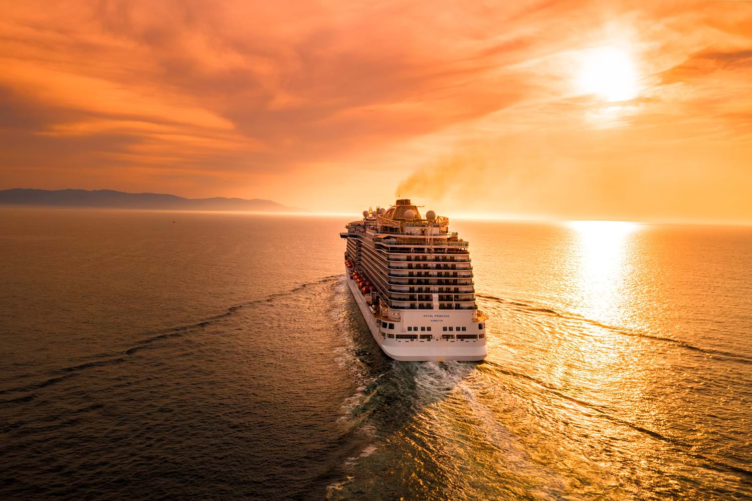 Cruise ship heading toward sunset