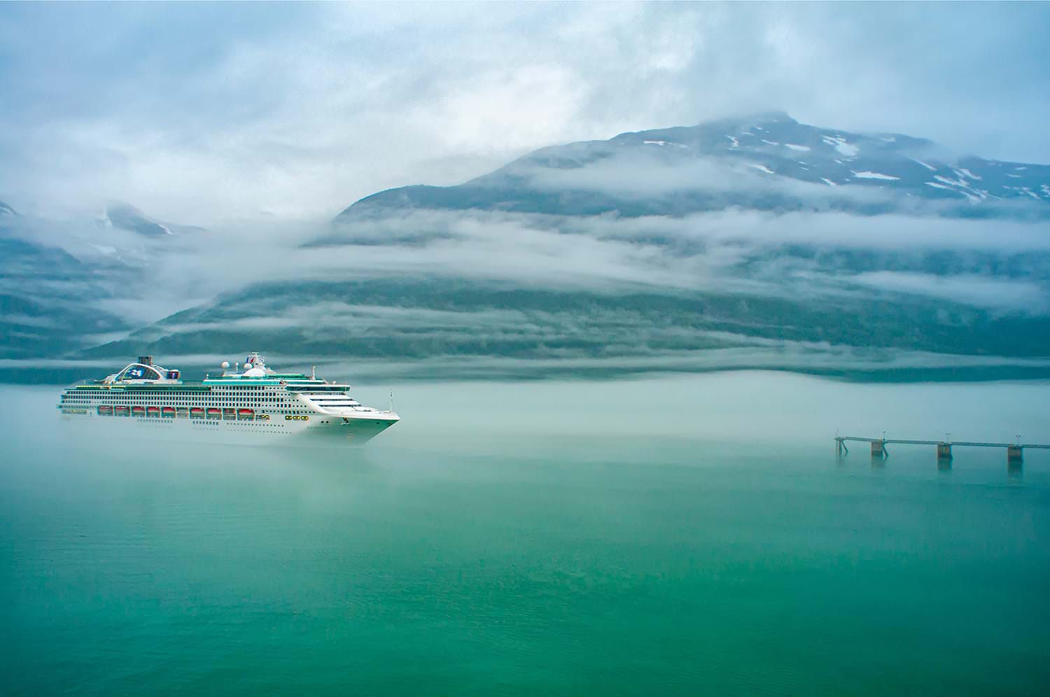 Cruise ship sailing through dense fog