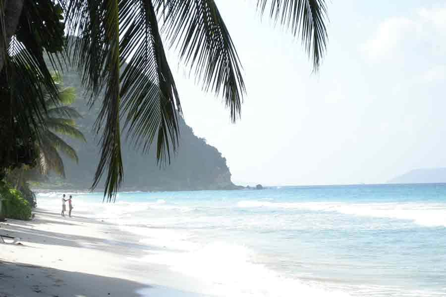 People standing on beach looking at the ocean in the British Virgin Islands