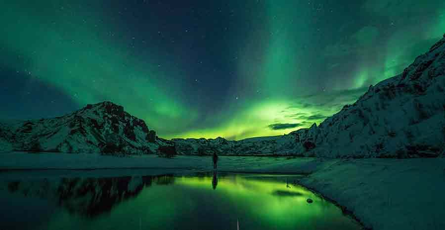 Person watching northern lights in Iceland