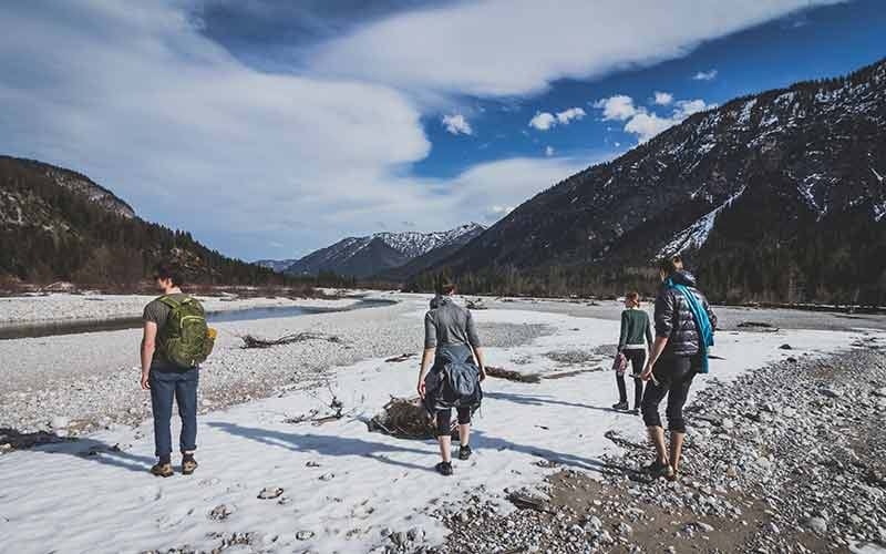 Group of people hiking through the mountains