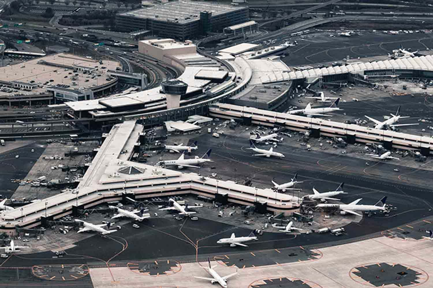 Above large airport full of docked planes