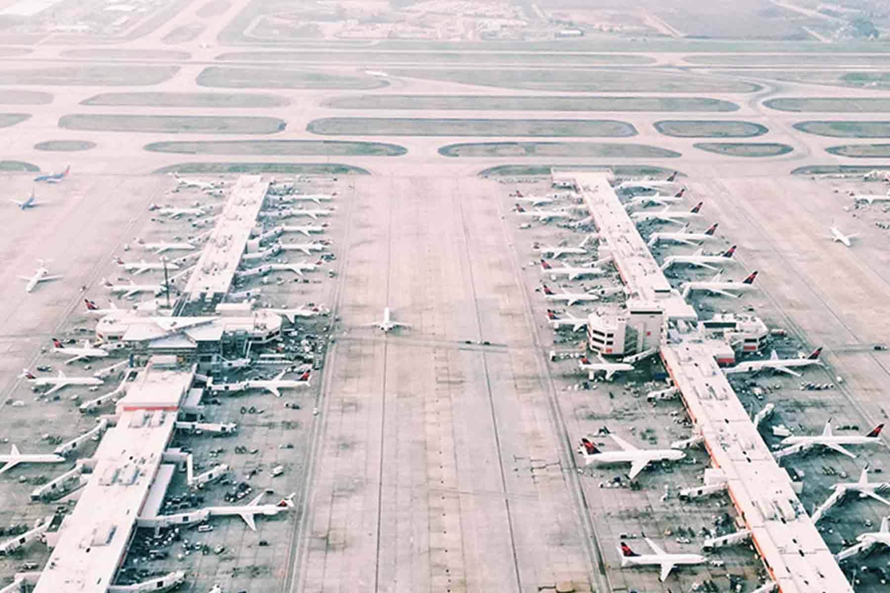 Rows of planes parked on airport tarmac